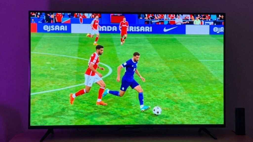 4K smart TV showing a sports game