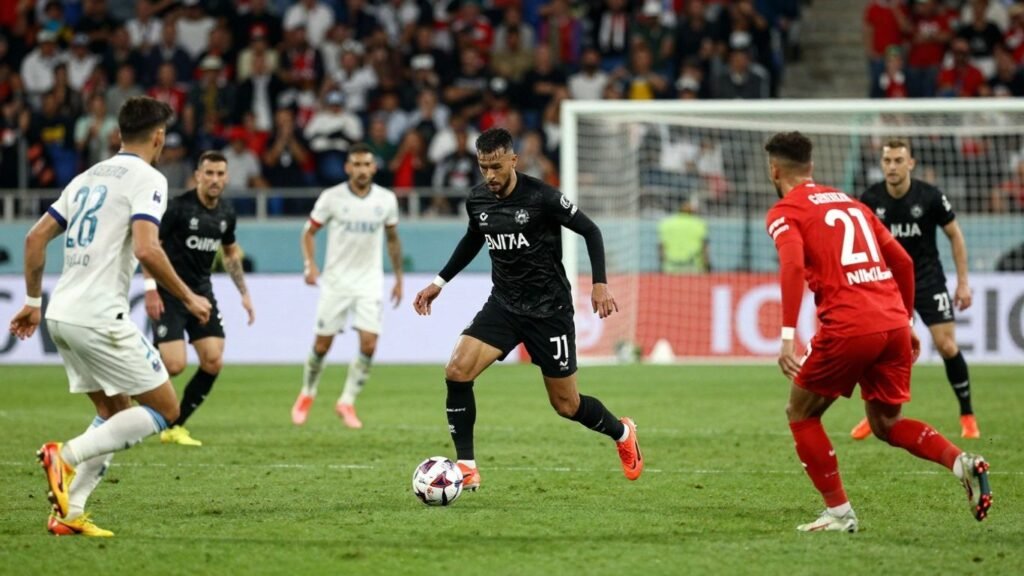Football match action with players and stadium.
